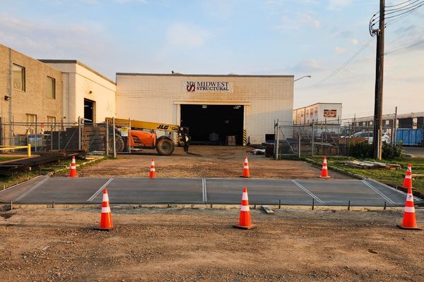 Large commercial concrete slab and structural pad poured for Midwest Structural in Edmonton.