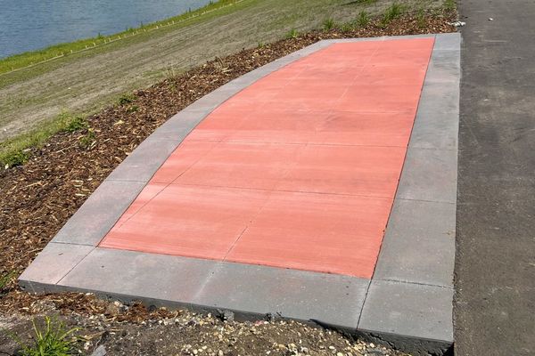 Custom colored concrete bench pad poured for Classic Landscapes in Spruce Grove.