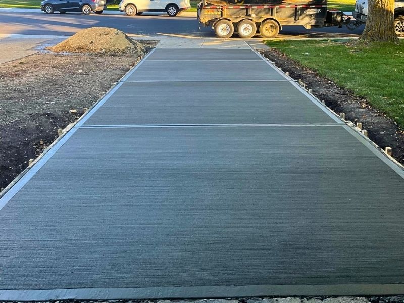 Freshly poured and professionally finished concrete sidewalk installation at a commercial property in Edmonton